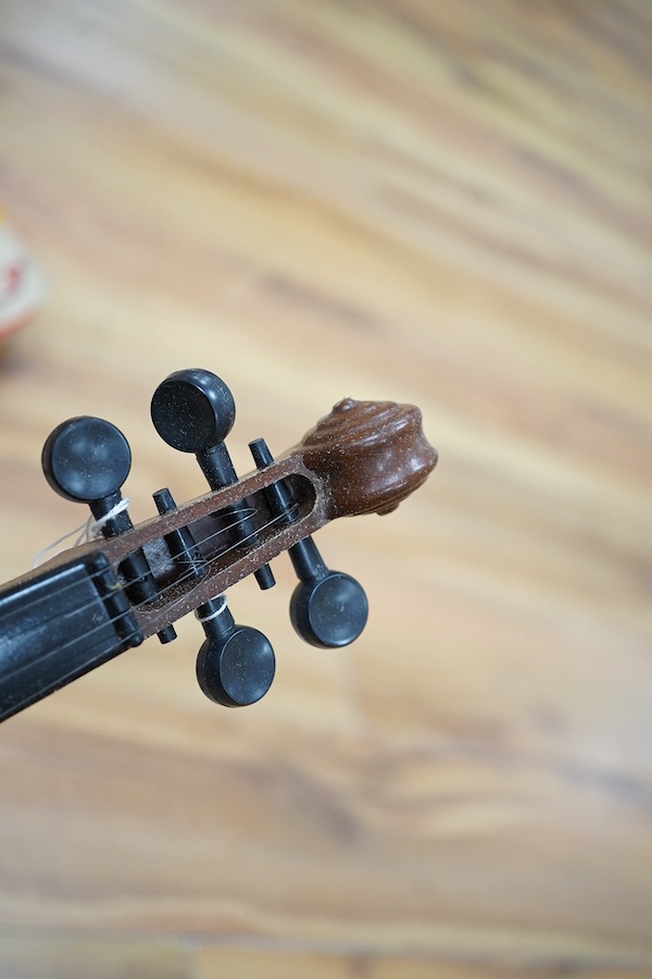 A quantity of violin parts and violins, a ukelele, a double bass scroll, a pinfold metronome, a violin case by Hill, a viola etc. Condition - for restoration